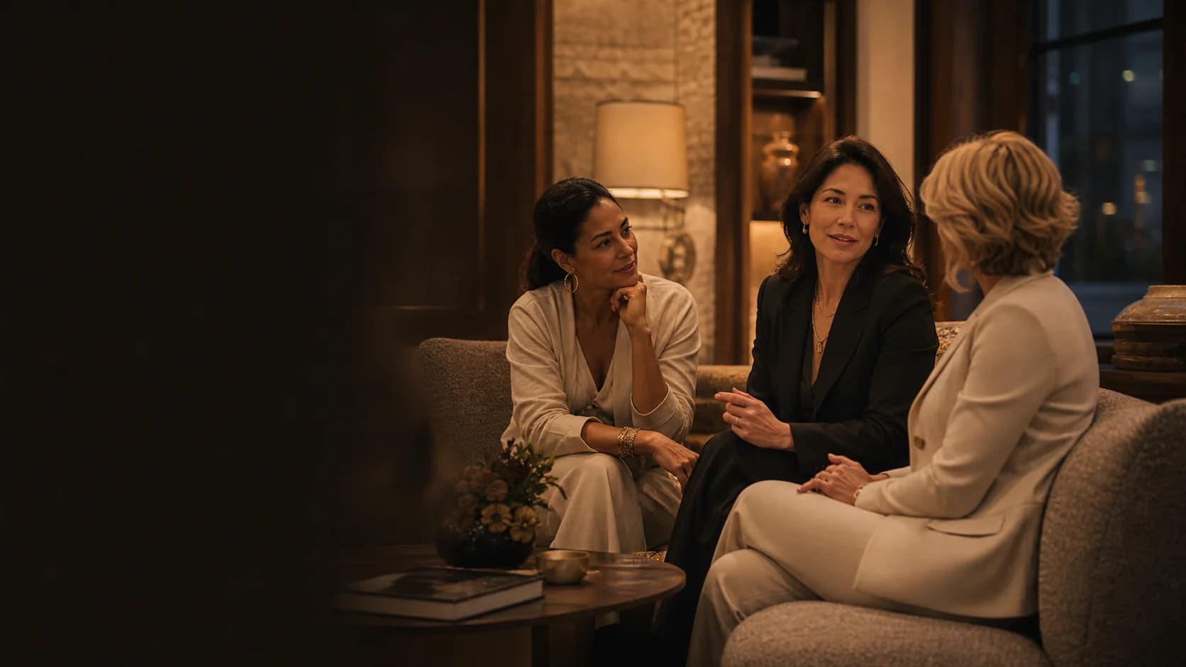 Three women in conversation in a discreet private salon